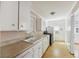 Functional kitchen with white cabinets, laminate countertops, and essential appliances at 634 Rutledge Ave, Charleston, SC 29403