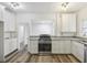 Stylish kitchen featuring white cabinets, granite countertops, and stainless steel appliances at 634 Rutledge Ave, Charleston, SC 29403