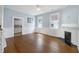 Inviting living room featuring hardwood floors, a fireplace, and access to the kitchen at 634 Rutledge Ave, Charleston, SC 29403