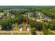 Aerial view of the property highlighting the house, surrounding neighborhood, and lush greenery at 689 W Butternut Rd, Summerville, SC 29483