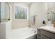 Modern bathroom features a soaking tub, stylish fixtures and a sunlit window at 689 W Butternut Rd, Summerville, SC 29483