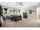 Spacious bedroom with tray ceiling, ceiling fan, neutral walls, and large windows, as well as dark furnishings at 689 W Butternut Rd, Summerville, SC 29483