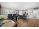 Open concept dining area featuring a dark wood table, seating for four, and a view into the kitchen at 689 W Butternut Rd, Summerville, SC 29483
