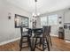Cozy dining area featuring a round table, four chairs, a modern chandelier, and natural lighting at 689 W Butternut Rd, Summerville, SC 29483