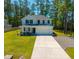 Two story home with a large yard, two car garage, and beautiful landscaping at 689 W Butternut Rd, Summerville, SC 29483