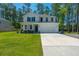 Charming two-story home with a manicured lawn, attached two-car garage, and covered front porch at 689 W Butternut Rd, Summerville, SC 29483