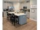 Spacious kitchen with a large island, stainless steel appliances, gray cabinets, and hardwood floors at 689 W Butternut Rd, Summerville, SC 29483