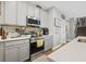 Well-equipped kitchen featuring stainless steel appliances, quartz countertops, and modern gray cabinetry at 689 W Butternut Rd, Summerville, SC 29483