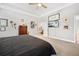 Spacious main bedroom features a tray ceiling, neutral tones and ensuite bathroom at 689 W Butternut Rd, Summerville, SC 29483
