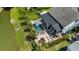 Aerial view of backyard with in-ground pool, covered lanai, black aluminum fence, and a view of the lake at 6910 Tanner Hall Blvd, Hanahan, SC 29410