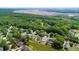 Scenic aerial view showcasing neighborhood homes amid lush trees and serene marshland at 6910 Tanner Hall Blvd, Hanahan, SC 29410