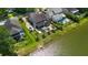 Aerial view of homes surrounding a lake, lush green landscaping, and in-ground pools in backyards at 6910 Tanner Hall Blvd, Hanahan, SC 29410