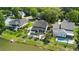Aerial view of neighborhood homes with in-ground pools and a lake surrounded by lush green trees at 6910 Tanner Hall Blvd, Hanahan, SC 29410