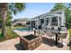 Expansive backyard with a pool, outdoor kitchen, dining area, and lush landscaping, perfect for entertaining at 6910 Tanner Hall Blvd, Hanahan, SC 29410