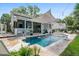 Stunning backyard with a sparkling pool, lush landscaping, and an outdoor lounge area for relaxation and entertainment at 6910 Tanner Hall Blvd, Hanahan, SC 29410