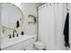 Bathroom featuring a round mirror and a white shower curtain at 6910 Tanner Hall Blvd, Hanahan, SC 29410