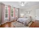 Bright bedroom features a plush bed, natural light, and soft pink accents at 6910 Tanner Hall Blvd, Hanahan, SC 29410