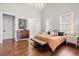 Bright bedroom boasts hardwood floors, high ceilings, and stylish furnishings at 6910 Tanner Hall Blvd, Hanahan, SC 29410