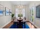 Bright dining room with wood floors, modern chandelier, and views of the backyard at 6910 Tanner Hall Blvd, Hanahan, SC 29410