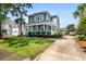 Charming two-story home boasts a spacious front porch, manicured landscaping, and classic architectural details at 6910 Tanner Hall Blvd, Hanahan, SC 29410