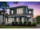 Charming two-story home boasts a spacious front porch, manicured landscaping, and classic architectural details at 6910 Tanner Hall Blvd, Hanahan, SC 29410