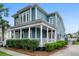 Charming two-story home boasts a spacious front porch, manicured landscaping, and classic architectural details at 6910 Tanner Hall Blvd, Hanahan, SC 29410