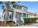 Charming two-story home boasts a spacious front porch, manicured landscaping, and classic architectural details at 6910 Tanner Hall Blvd, Hanahan, SC 29410