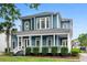 Charming two-story home boasts a spacious front porch, manicured landscaping, and classic architectural details at 6910 Tanner Hall Blvd, Hanahan, SC 29410