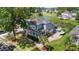 Exterior shot of a blue two story home with a porch, landscaping, long driveway and attached garage at 6910 Tanner Hall Blvd, Hanahan, SC 29410