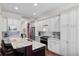 Open kitchen with white cabinetry, granite countertops, stainless appliances, and large island at 6910 Tanner Hall Blvd, Hanahan, SC 29410