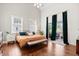 Spacious main bedroom features a vaulted ceiling, hardwood floors, and private balcony access at 6910 Tanner Hall Blvd, Hanahan, SC 29410