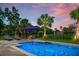 Beautiful in-ground pool with water features and fire pit on a fenced lot with lounge chairs at 6910 Tanner Hall Blvd, Hanahan, SC 29410