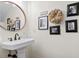 Charming powder room with pedestal sink, decorative mirror, and stylish decor at 6910 Tanner Hall Blvd, Hanahan, SC 29410