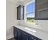 Elegant kitchen features stylish blue cabinetry, white countertops, and modern stainless steel appliances at 708 Breakers Reef Ln, Huger, SC 29450