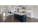 Spacious kitchen featuring a large island with seating, stainless steel appliances, and ample cabinet space at 708 Breakers Reef Ln, Huger, SC 29450