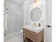 Beautiful bathroom boasts a glass enclosed shower with modern fixtures, plus a floating vanity with stone countertop at 71 Moultrie St, Charleston, SC 29403