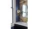 Stylish bathroom features a gold faucet, vanity mirror and custom lighting and decor at 71 Moultrie St, Charleston, SC 29403