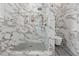 Elegant bathroom features marble tile shower, black and white floor tiles, and brass shower fixtures at 71 Moultrie St, Charleston, SC 29403