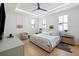 Spacious primary bedroom features a king-sized bed, wood floors and bright, natural light at 71 Moultrie St, Charleston, SC 29403