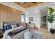 Relaxing bedroom showcases modern design, custom wood paneling, desk area and an ensuite at 71 Moultrie St, Charleston, SC 29403