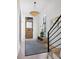 Elegant foyer with a decorative light fixture, stylish rug, and staircase, creating a welcoming entry at 71 Moultrie St, Charleston, SC 29403