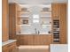 Bright butler's pantry featuring custom oak cabinets, open shelves, elegant marble backsplash, and a wine refrigerator at 71 Moultrie St, Charleston, SC 29403