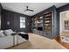 Stylish living room with custom built-in shelving, modern furniture, and wood floors for an inviting atmosphere at 71 Moultrie St, Charleston, SC 29403