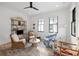 Cozy living room featuring bright white walls, wicker seating, and windows offering an abundance of light at 71 Moultrie St, Charleston, SC 29403