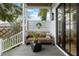 Inviting covered porch featuring a comfortable cushioned sofa and modern accent table at 71 Moultrie St, Charleston, SC 29403