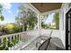 Inviting covered porch with seating area offering a relaxing outdoor space with views of the backyard at 71 Moultrie St, Charleston, SC 29403