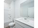 Well-lit bathroom featuring a shower-tub combo, modern vanity, and an ample mirror at 740 Meadowbrook Lane, Summerville, SC 29486