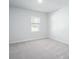 Cozy bedroom with plush gray carpet, a window with natural light, and neutral wall paint at 740 Meadowbrook Lane, Summerville, SC 29486