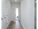 Bright hallway features wood flooring, white walls, and an open door with natural light streaming in at 740 Meadowbrook Lane, Summerville, SC 29486