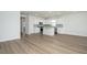 Open concept kitchen features an island, stainless appliances, white cabinets, and wood-look flooring at 740 Meadowbrook Lane, Summerville, SC 29486